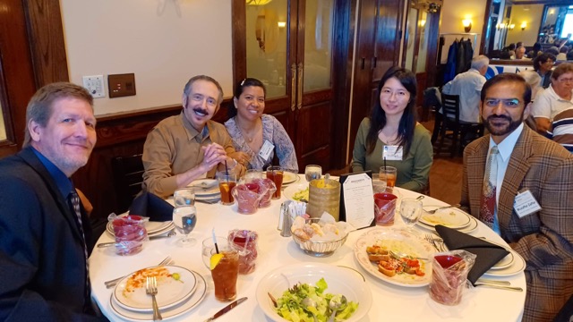 Around a table: Arnold and Maria Pachtman, Gouling C, and Section Treasurer Muzaffar Zaffar