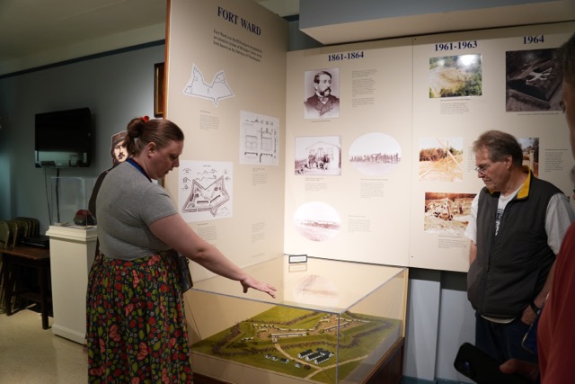Pointing out the original and enlarged fort configurations